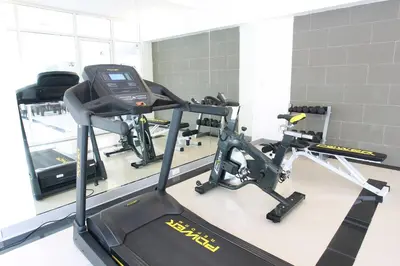 a gym with two treadmills and a treadmill at Lee Garden Bangkok in Bangkok