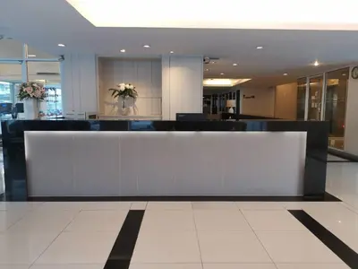 a lobby with a reception desk in a building at Lee Garden Bangkok in Bangkok