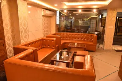 a lobby with two leather couches and a table at Rose Nana Hotel in Bangkok