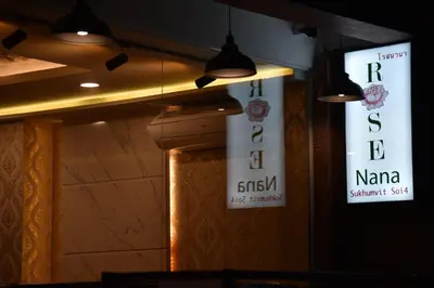 two signs on the wall of a restaurant at Rose Nana Hotel in Bangkok