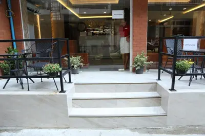 a group of benches and chairs in front of a store at Rose Nana Hotel in Bangkok
