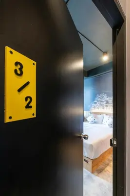 an open door to a bedroom with a bed at LOBSUEK Hostel in Bangkok