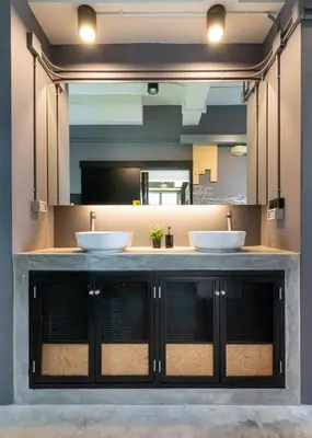 a bathroom with two sinks in front of a mirror at LOBSUEK Hostel in Bangkok