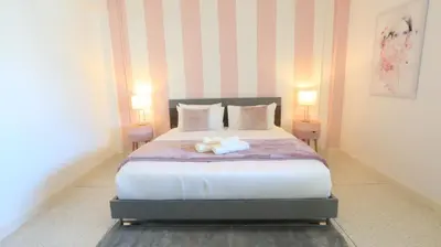 a bedroom with a bed with two towels on it at Airee Premier Residence in Bangkok