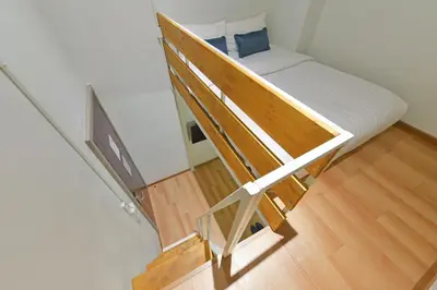 a bunk bed in a room with a staircase at StayAt Bedever Bangkok Hotel in Bangkok