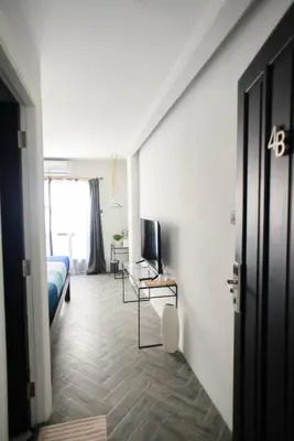 a room with a bed and a television on a table at 87 Oldtown at River Pier in Bangkok