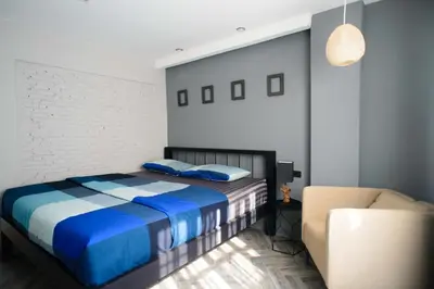 a bedroom with a bed and a chair at 87 Oldtown at River Pier in Bangkok