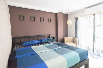 a bedroom with a blue and white bed and a window at 87 Oldtown at River Pier in Bangkok