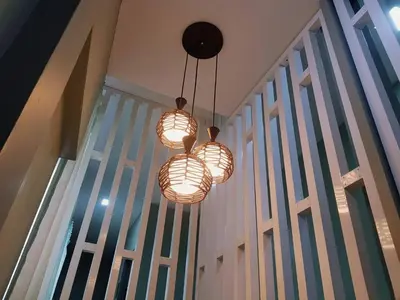 two lights hanging from a ceiling with a window at Baan U-Sabai บ้านอยู่สบาย in Bangkok
