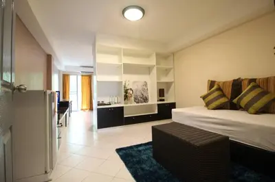 a bedroom with a bed and a living room at ลีลาวดี ซอยมหาดไทย รามคำแหง65 Mahadthai in Bangkok