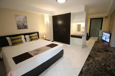 a bedroom with a large bed and a television at ลีลาวดี ซอยมหาดไทย รามคำแหง65 Mahadthai in Bangkok