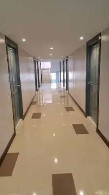 an empty hallway in a building with glass doors at ลีลาวดี ซอยมหาดไทย รามคำแหง65 Mahadthai in Bangkok