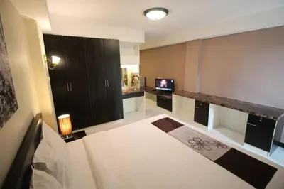 a living room with a bed and a television at ลีลาวดี ซอยมหาดไทย รามคำแหง65 Mahadthai in Bangkok