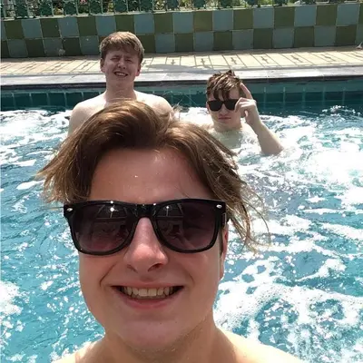 a man wearing sunglasses in a swimming pool at Studio Suite by Royal Ivory Nana in Bangkok