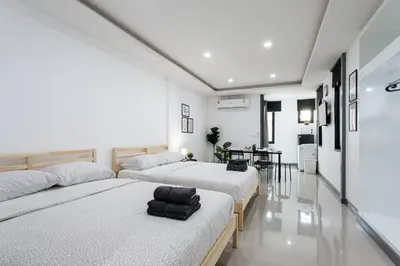 two beds in a room with white walls at P4 Silom Large 2beds full kitchen WIFI 4-6pax in Bangkok