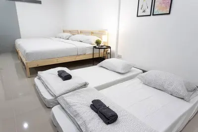 a room with three beds with towels on them at P4 Silom Large 2beds full kitchen WIFI 4-6pax in Bangkok