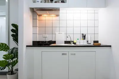 a kitchen with white cabinets and a sink at P4 Silom Large 2beds full kitchen WIFI 4-6pax in Bangkok
