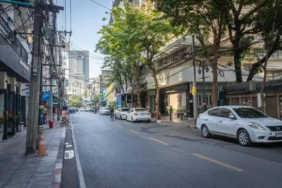 a city street with cars parked on the side of the road at P4 Silom Large 2beds full kitchen WIFI 4-6pax in Bangkok