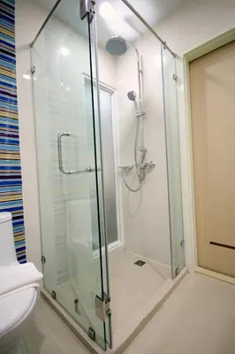 a glass shower in a bathroom with a toilet at S3 Residence Park in Bangkok
