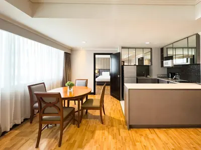 a kitchen and dining room with a table and chairs at Rembrandt Residences Bangkok in Bangkok