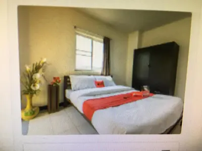 a bedroom with a bed and a window at BM Mansion in Bangna