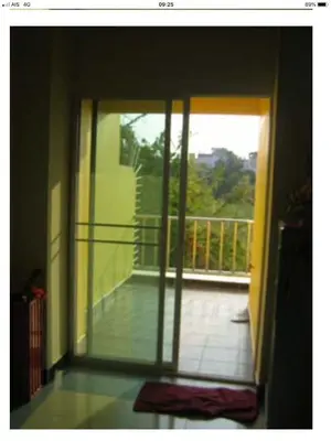 a room with a door open to a balcony at BM Mansion in Bangna
