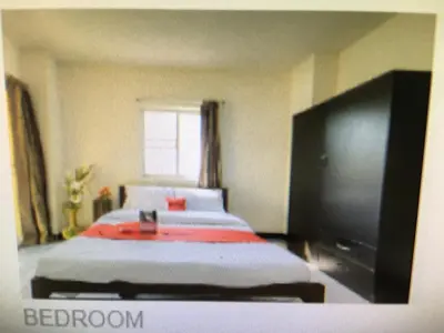 a bedroom with a bed and a flat screen tv at BM Mansion in Bangna