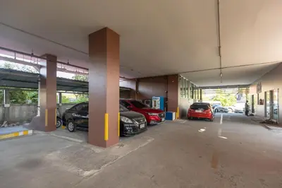 a parking garage with cars parked in it at BM Mansion in Bangna