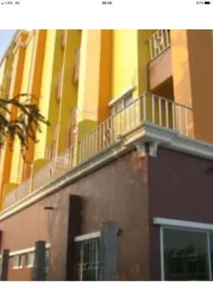a building with a balcony on the side of it at BM Mansion in Bangna