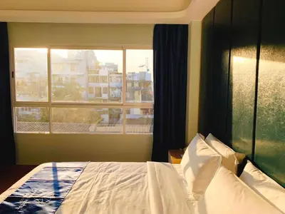 a bedroom with a bed and a large window at Sapphire Hotel Silom Bangkok in Bangkok