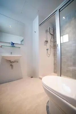 a bathroom with a toilet and a sink and a shower at Star Sukhumvit in Bangkok