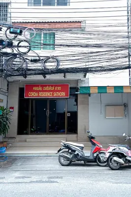 two motorcycles parked in front of a building at Cordia Residence Sathorn in Bang Rak