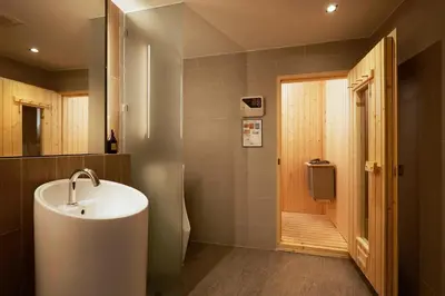 a bathroom with a sink and a walk in shower at The Quarter Phromphong by UHG in Bangkok
