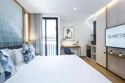 a hotel room with a bed and a tv at The Quarter Phromphong by UHG in Bangkok
