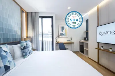 a hotel room with a bed and a tv at The Quarter Phromphong by UHG in Bangkok