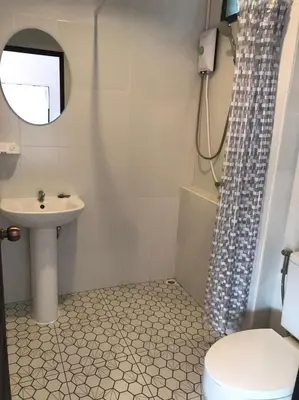 a bathroom with a sink and a toilet and a shower at BAANYA HOMESTAY Ko Kret in Nonthaburi