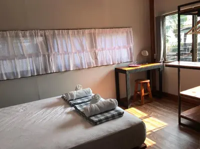 a bedroom with a bed with towels on it at BAANYA HOMESTAY Ko Kret in Nonthaburi