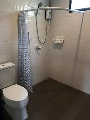 a bathroom with a toilet and a shower at BAANYA HOMESTAY Ko Kret in Nonthaburi