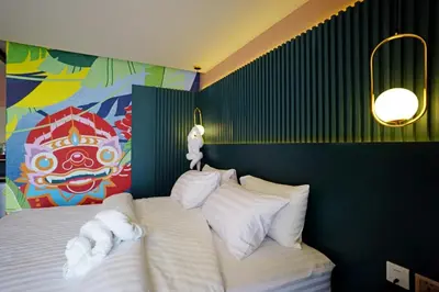 a bedroom with a bed with towels on it at 4 Monkeys Hotel in Bangkok