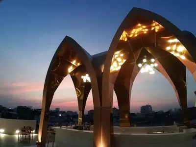 a view of a rooftop at night with lights at 4 Monkeys Hotel in Bangkok