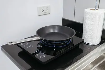 a pan sitting on top of a stove in a kitchen at P2 Silom Large 2beds full kitchen WIFI 4-6pax in Bangkok