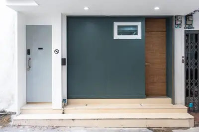 a blue door on a house with steps at P3 Silom Large 2beds full kitchen WIFI 4-6pax in Bangkok