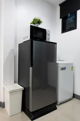 a black refrigerator with a microwave on top of it at P3 Silom Large 2beds full kitchen WIFI 4-6pax in Bangkok