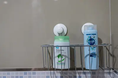 a shelf with two bottles of toothpaste and a moisturizer at P3 Silom Large 2beds full kitchen WIFI 4-6pax in Bangkok