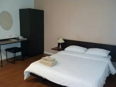 a bedroom with a large white bed with towels on it at G9bangkok in Bangkok