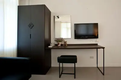 a room with a desk with a television and a chair at G9bangkok in Bangkok