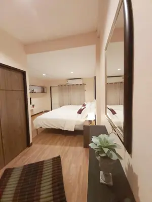 a bedroom with a bed and a large mirror at Real Bangkok Guesthouse Private 3BR Home 3 Min to BTS Ratchathewi in Bangkok
