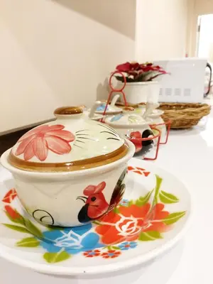a tea cup on a plate on a table at Real Bangkok Guesthouse Private 3BR Home 3 Min to BTS Ratchathewi in Bangkok