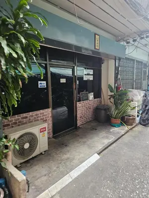 a front door of a building with a fan at Real Bangkok Guesthouse Private 3BR Home 3 Min to BTS Ratchathewi in Bangkok