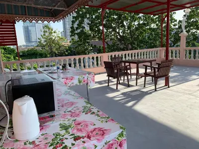 a patio with a table with a computer on it at Gaiwandhanat Homestay in Bangkok